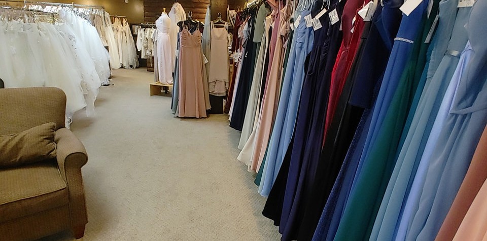 View of many long floor-length dresses both white and different colors