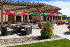 Outdoor Patio with chairs and a fire pit and lots of umbrellas for shade